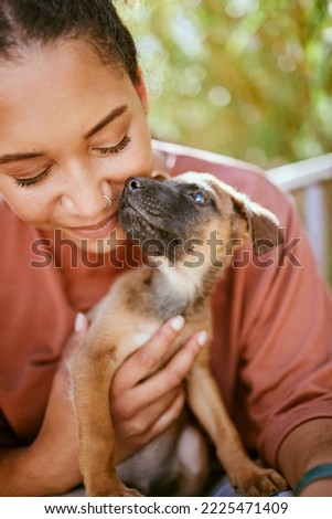 Love, care and pet dog with black woman in garden for bond, affection and happiness together. Wellness, calm and healthy adoption puppy bonding embrace with happy girl owner in backyard.