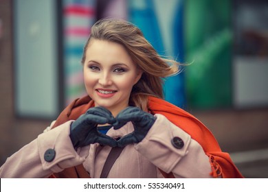 Love. Closeup Portrait Smiling Happy Young Woman Making Heart Sign, Symbol With Hands Isolated City Scape Background. Positive Human Emotion Expression Feeling Life Perception Attitude Body Language