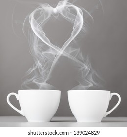 Love And Coffee. Heart Silhouette From Steaming Hot Coffee Cups