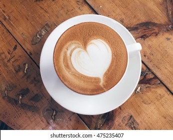 Love Coffee,A Cup Of Latte Art With Heart Pattern In A White Cup On Wooden Background