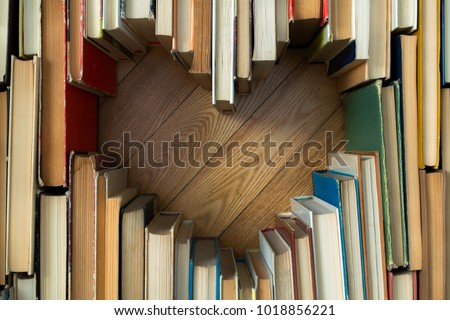 Love concept of heart shape from old vintage books on wooden floor background