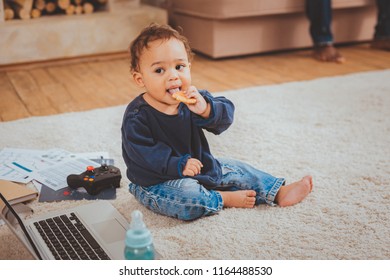 I Love Cookies. Charming Afro-american Toddler Sitting On The Floor And Eating A Cookie