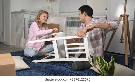 Love couple assembly new home ikea furniture. Family moving into house. Joyful guy buy hand made chair. Girl sit floor. People do kitchen renovation. Man rent flat. Team work craft diy. Manual repair. - Powered by Shutterstock