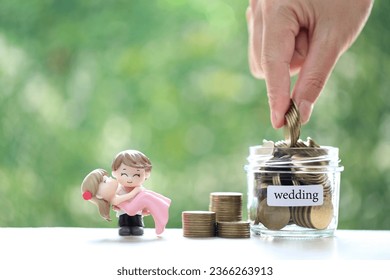 Love couple with coins money in the glass bottle on natural green background, Save money for wedding or family and save money for prepare in future concept - Shutterstock ID 2366263913