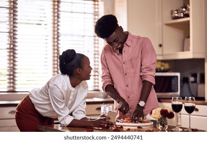 Love, couple and cooking in kitchen with phone on valentines day for online recipe and lunch date in home. Black people, romance and happy with bonding, healthy meal preparation or dinner celebration - Powered by Shutterstock