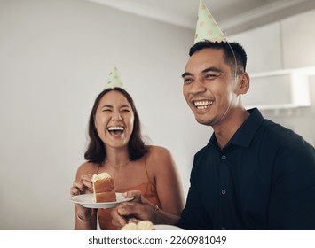 Love, couple eating cake and birthday party with smile, loving and celebration for achievement and joyful. Romantic, man and woman with hats, dessert and laughing together in living room and cheerful - Powered by Shutterstock