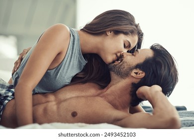 Love, couple and kiss in bedroom for relax, romance and bonding together for care in home. Morning, man and intimate woman in bed for healthy relationship, connection or support with passion in house - Powered by Shutterstock