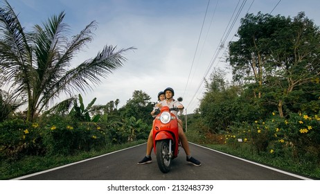 Love couple on red motorbike in white clothes to go on forest road trail trip. Two caucasian tourist woman man drive on scooter. Motorcycle rent, safety helmet, sunglasses. Asia Thailand ride tourism. - Powered by Shutterstock