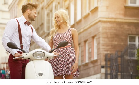 Love Couple On The Street With Retro Scooter