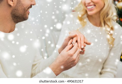 Love, Couple, Relationship And Holidays Concept - Happy Man Giving Diamond Ring To Woman For Christmas