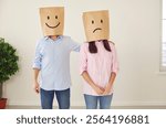 Love couple stand together paper bags on heads emotions happy and unhappy. Paper bags funny scene explore spectrum of emotions touch of fun to their life Heads in paper bags with smile and sad