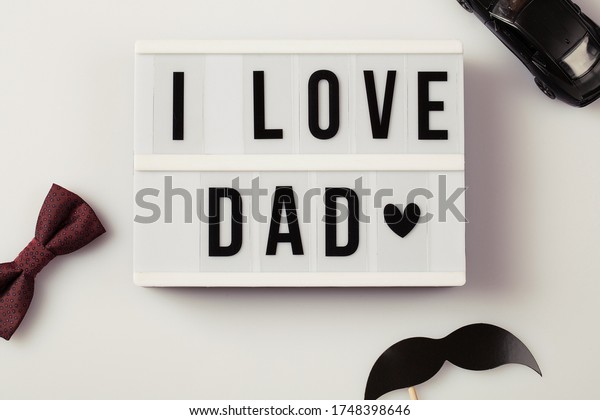 i love dad, Father\'s Day lightbox\
message with mustache black car and red bow tie. top\
view
