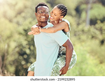 Love, date and outdoor couple in park or romantic nature outing for healthy, green lifestyle with trees, bokeh and lens flare. Happy, wellness black people and caring man giving woman piggyback ride
