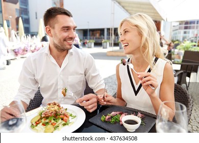 Love, Date, People, Holidays And Relations Concept - Happy Couple Eating Salad For Dinner At Cafe Or Restaurant Terrace