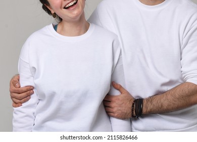 Love And Family Concept. Closeup Man And Woman In White Longsleeves Smiling And Hugging. Isolated On White. No Faces.