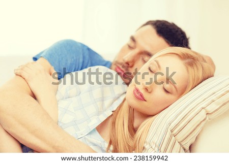 love, family and happiness concept - smiling happy couple sleeping at home