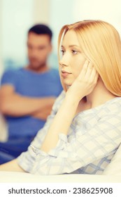 Love, Family And Happiness Concept - Upset Young Woman With Man On The Back At Home