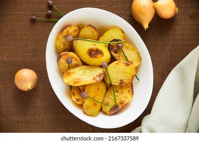 Love At First Bite. Overhead Shot Of Roasted Potatoes In A White Serving Bowl.