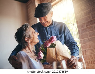 Love, Flowers And Gift Of A Senior Couple In Celebration, Joy And Happiness Of A Birthday, Anniversary Or Milestone. Elderly Man And Woman, Happy, Romantic And Smiling Together In A Retirement Home