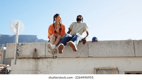 Love, friendship and a couple sitting on rooftop of city building in summer time. Diversity, friends and romance, gen z urban dating for happy woman and black man with smile and skateboard on date. - Shutterstock ID 2264496955