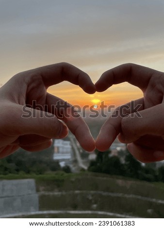 Love handsign with sunset background
