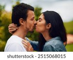 Love, happy and couple kiss in park for bonding, relax together and relationship outdoors. Dating, travel and man and woman with affection for romance on holiday, vacation and weekend in nature