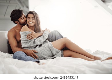 Love, happy and couple on bed in hotel on weekend morning for romantic anniversary getaway. Smile, relax and young man and woman with embracing, cuddle or intimacy in bedroom together at holiday home - Powered by Shutterstock