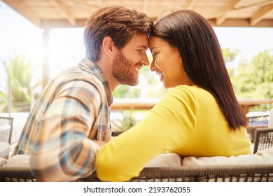 Love, happy couple relax on a patio at new house or home on the weekend. Young married man and woman bonding on valentines day or marriage anniversary with intimate look before a kiss - Powered by Shutterstock