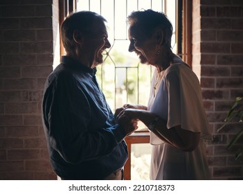 Love, Happy Family And Senior Couple Laugh And Relax In Dark Room, Bond And Share Funny Joke In Their Home. Retirement, Humour And Affection By Sweet Elderly Man And Woman Smile, Enjoy Time Together