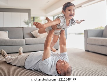 Love, Happy Grandfather And Girl Play In Living Room And Laugh, Fun And Smile Together. Grandparent Lifting Grandchild At Home In Lounge And Enjoy Bonding, Carefree And Relax On Floor On Weekend.