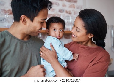 Love, happy parents and baby with down syndrome in the kitchen embracing and bonding in their home. Happiness, smile and family care with special needs or disabled child standing together in a house. - Shutterstock ID 2210718807