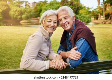 Love Has No Age. Portrait Of A Happy Senior Couple Sitting On A Park Bench.