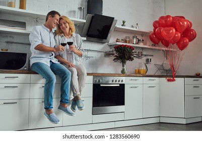 Love has no age! Romantic senior couple celebrating Saint Valentine's Day at home. Beautiful woman and handsome man enjoying spending time together. Happy Saint Valentine's Day! - Powered by Shutterstock