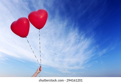 Love heart balloons on sky background