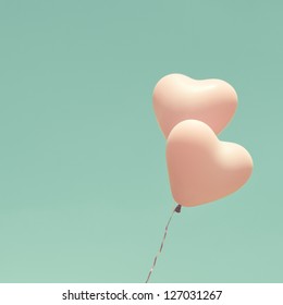 Love heart balloons on vintage sky