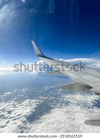 Love heart in the clouds while flying looking out the airplane window