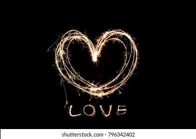 Love and heart made from fireworks on black background Valentine Day  - Powered by Shutterstock