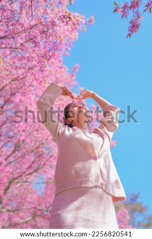 Similar – Woman with sunglasses raising her arms over nature background