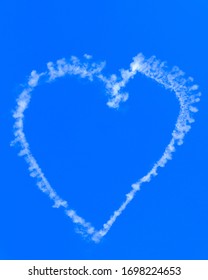 A Love Heart Shape Made With Smoke From A Sky Writing Airplane Against A Blue Sky