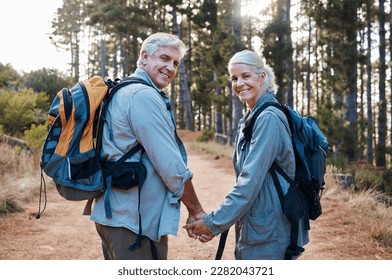 Love, hiking and portrait of old couple holding hands on nature walk in mountain forest in Canada. Travel, senior man and woman on hike with smile on face and health on retirement holiday adventure. - Powered by Shutterstock