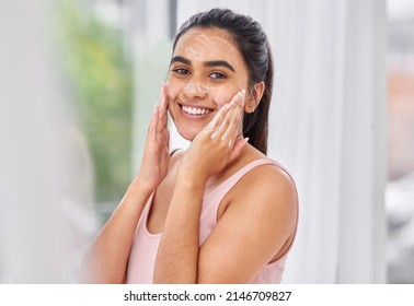 I Love How This Product Makes My Skin Feel. Cropped Shot Of A Young Woman Washing Her Face In The Bathroom.