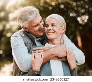 Love, hug and senior couple at a park happy, free and enjoy travel, holiday or weekend outdoor. Face, smile and elderly man embrace woman in forest, bond and having fun on retirement trip together - Powered by Shutterstock