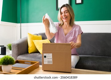 I Love It! Happy Older Woman Opening A Package With Her Online Purchases