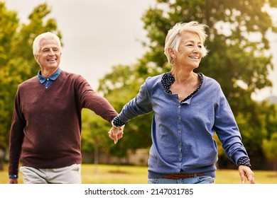 Love keeps a marriage alive. Shot of a happy senior couple going for a walk in the park. - Shutterstock ID 2147031785