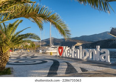 I Love Kefalonia sign on the waterfront of Argostoli Town on Kefalonia island, Ionian sea, Greece. Argostolion harbour and beautiful waterfront with palm trees.
