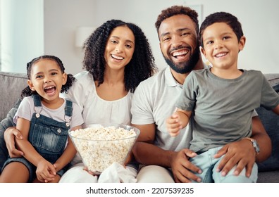 Love, Laugh And Watching Tv Or A Movie With A Happy Family Eating Popcorn, Having Fun And Smile Together In Home. Portrait Of Latino Parents And Children, Enjoy The Weekend And Feeling Carefree