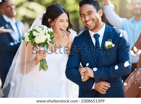 Love, laughing and couple walking at their wedding with guests in celebration of romance. Happy, smile and young bride with bouquet and groom with crowd celebrating at the outdoor marriage ceremony.