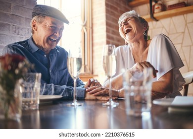 Love, laughing and old couple holding hands at a restaurant on a romantic wine date in celebration of a happy marriage. Smile, relaxed and senior woman enjoying glass of champagne with funny partner - Powered by Shutterstock