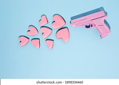 Love Layout Made With Pink Gun Firing A Pink Heart Shaped Cookies On A Pink Background. Creative Broken Heart, Food, Valentines Or Romantic Concept. Flat Lay, Top View.