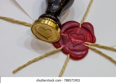 Love letter with red wax seal, stamp and feather pen/ Valentine's day concept - Powered by Shutterstock